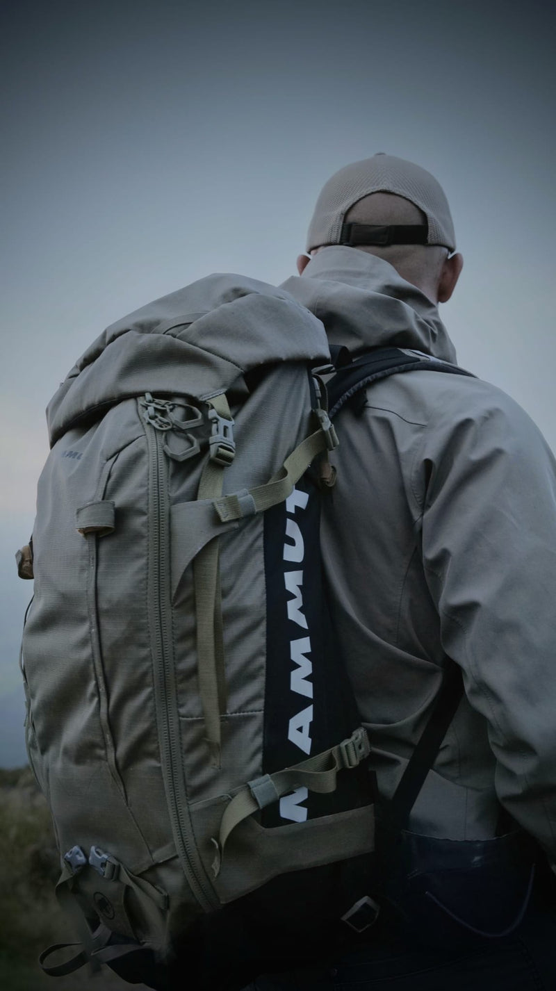 Hiker wearing waterproof clothing in wet conditions on a UK hill