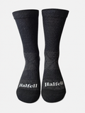 Pair of Halfell Merino Socks, front view showing the Halfell logo on the ribbed cuff
