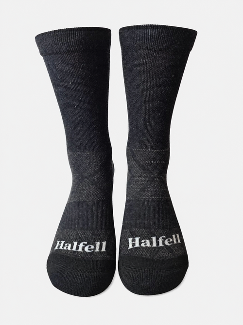 Pair of Halfell Merino Socks, front view showing the Halfell logo on the ribbed cuff